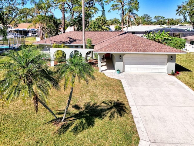 mediterranean / spanish-style home featuring a front yard, driveway, a shingled roof, stucco siding, and a garage