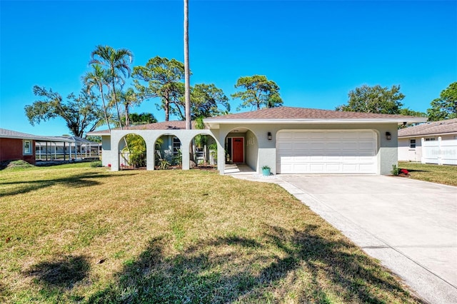 view of front of house featuring a front lawn, an attached garage, driveway, and stucco siding