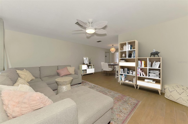 living area featuring ceiling fan and wood finished floors