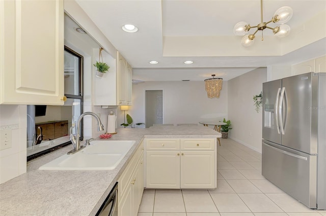 kitchen with a sink, a peninsula, a raised ceiling, and stainless steel fridge with ice dispenser