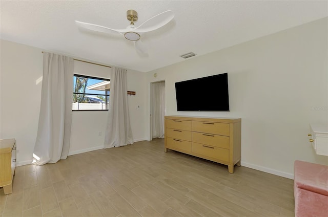 unfurnished bedroom with visible vents, baseboards, light wood-type flooring, a textured ceiling, and a ceiling fan