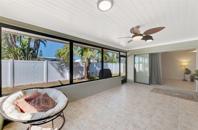 sunroom featuring wood ceiling and ceiling fan