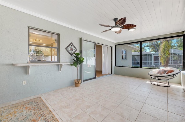 unfurnished sunroom with wood ceiling and a ceiling fan