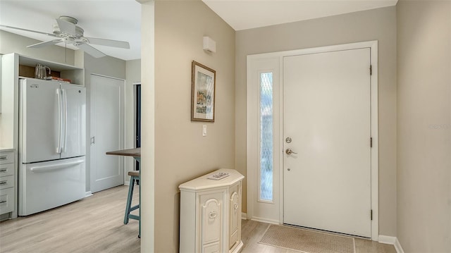 entrance foyer featuring a ceiling fan, light wood-style floors, baseboards, and a healthy amount of sunlight