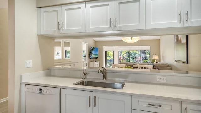 bar with white dishwasher and a sink