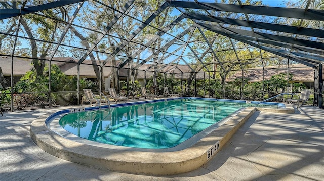 pool featuring a lanai and a patio area