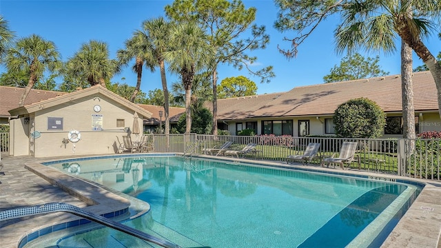 pool featuring a patio area and fence