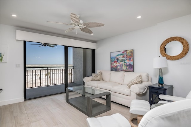 living room featuring recessed lighting, baseboards, a ceiling fan, and wood finished floors