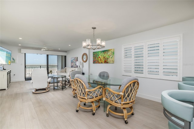 dining area with recessed lighting, baseboards, light wood-style flooring, and ceiling fan with notable chandelier