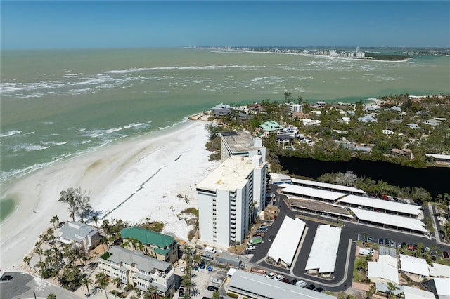 birds eye view of property featuring a view of the beach and a water view