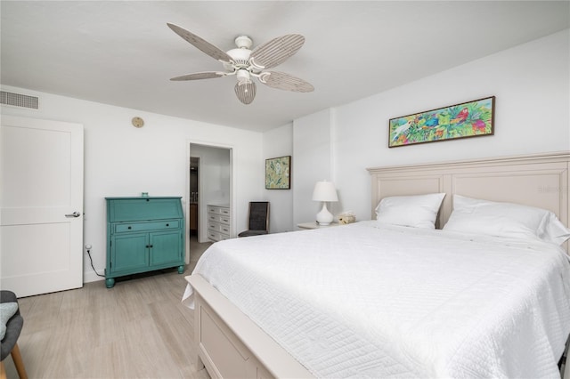 bedroom featuring visible vents, light wood finished floors, and ceiling fan