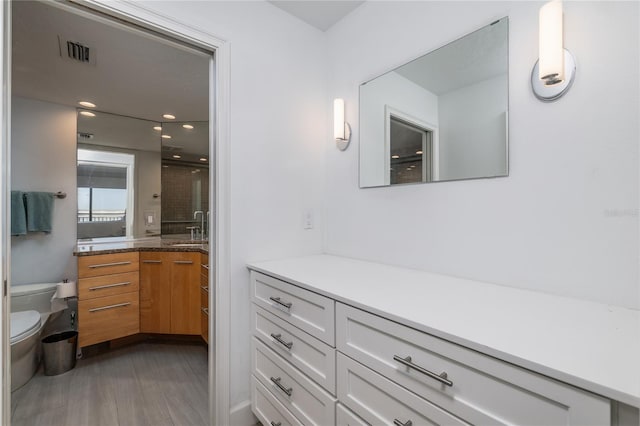 bathroom featuring visible vents, a shower stall, toilet, recessed lighting, and vanity