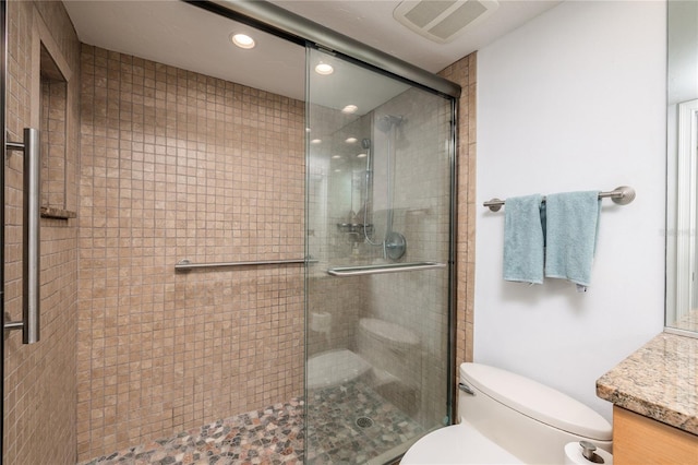 bathroom with visible vents, toilet, recessed lighting, a stall shower, and vanity