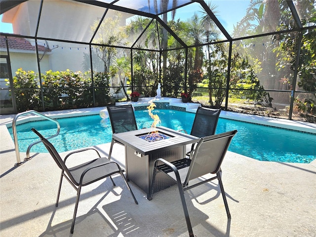 outdoor pool with a patio area, a fire pit, and a lanai