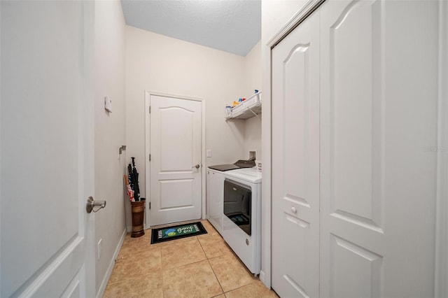 2114 147th Ct E, Bradenton, FL 34212 - laundry area featuring light tile patterned floors, baseboards, washing machine and dryer, and laundry area