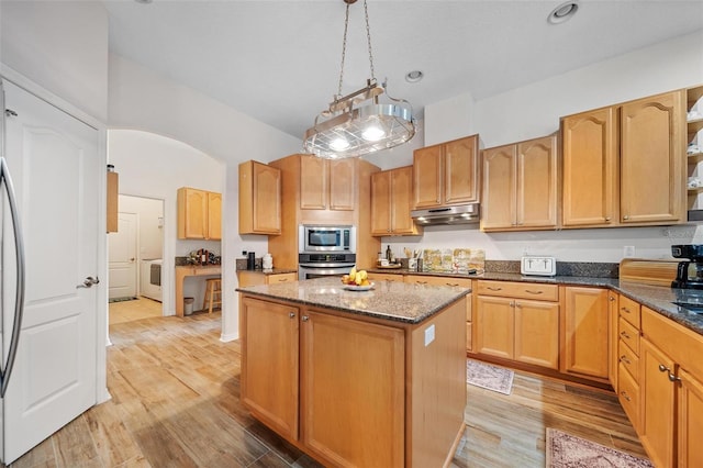 2114 147th Ct E, Bradenton, FL 34212 - kitchen featuring light wood-style flooring, a kitchen island, dark stone countertops, appliances with stainless steel finishes, and under cabinet range hood