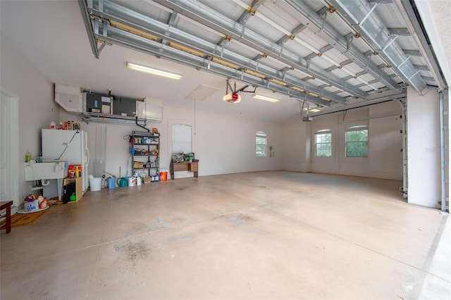 2114 147th Ct E, Bradenton, FL 34212 - garage with a garage door opener and freestanding refrigerator