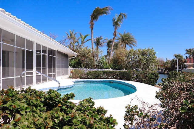 outdoor pool featuring a sunroom