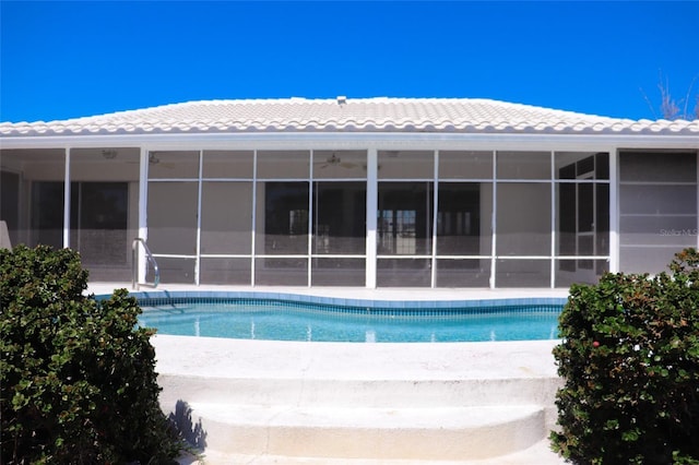 pool with a patio area, a ceiling fan, and a sunroom