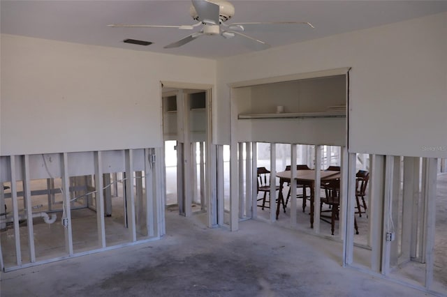 interior space with visible vents and a ceiling fan