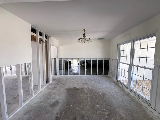 empty room featuring visible vents and an inviting chandelier