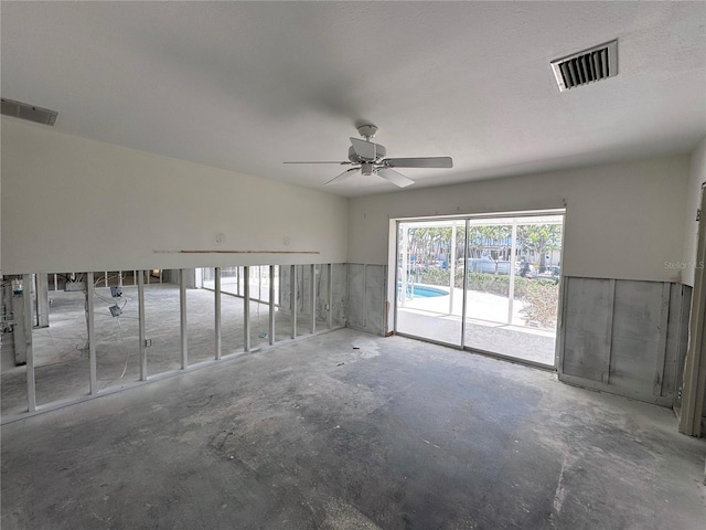 empty room featuring visible vents, concrete floors, and ceiling fan