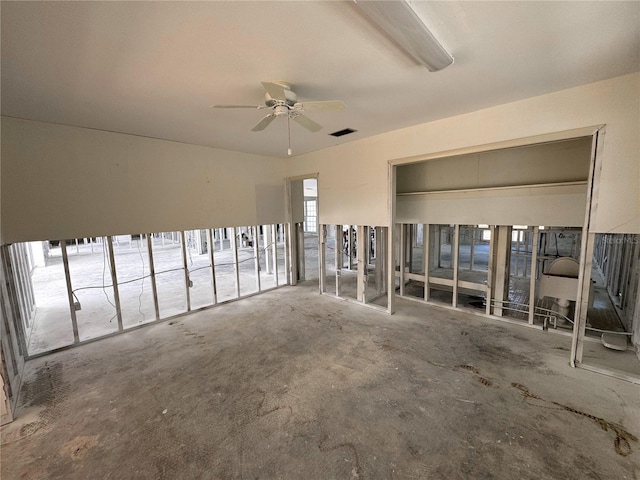 interior space featuring a ceiling fan and visible vents