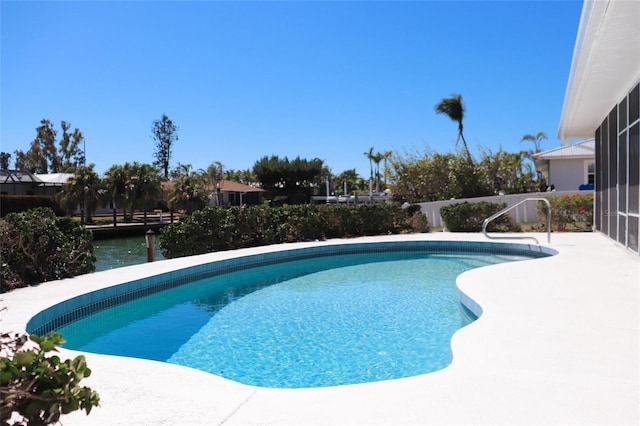 outdoor pool featuring a patio and fence