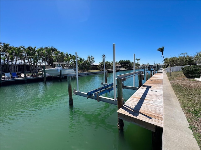 dock area with a water view and boat lift