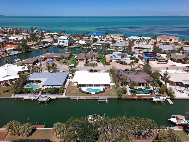 birds eye view of property featuring a water view and a residential view