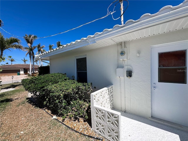 doorway to property with stucco siding