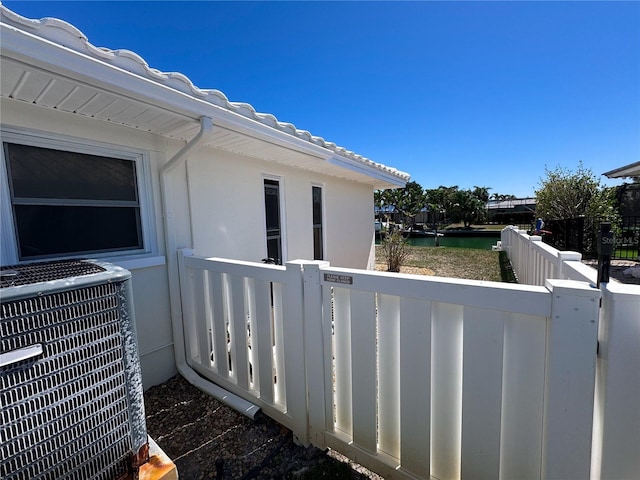 balcony with a water view and central AC unit