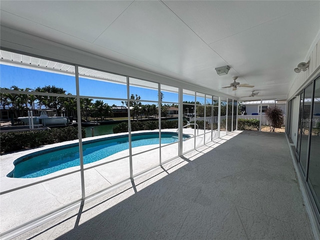 outdoor pool with a ceiling fan and a patio area