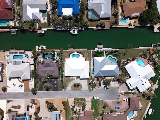 birds eye view of property with a residential view and a water view