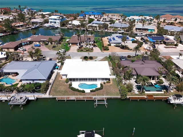 drone / aerial view with a residential view and a water view