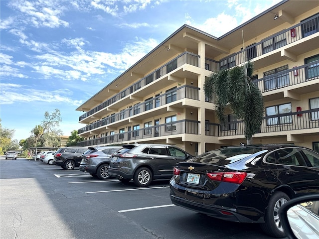 view of building exterior with uncovered parking