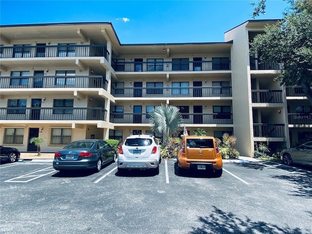 view of building exterior featuring uncovered parking