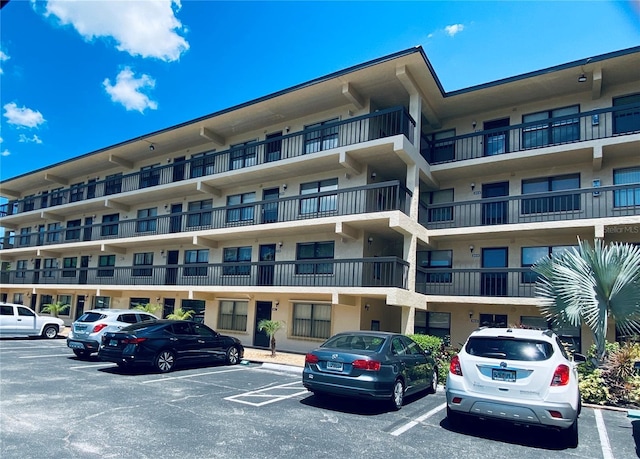 view of building exterior featuring uncovered parking