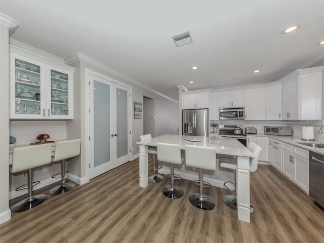 kitchen with white cabinets, french doors, visible vents, and appliances with stainless steel finishes