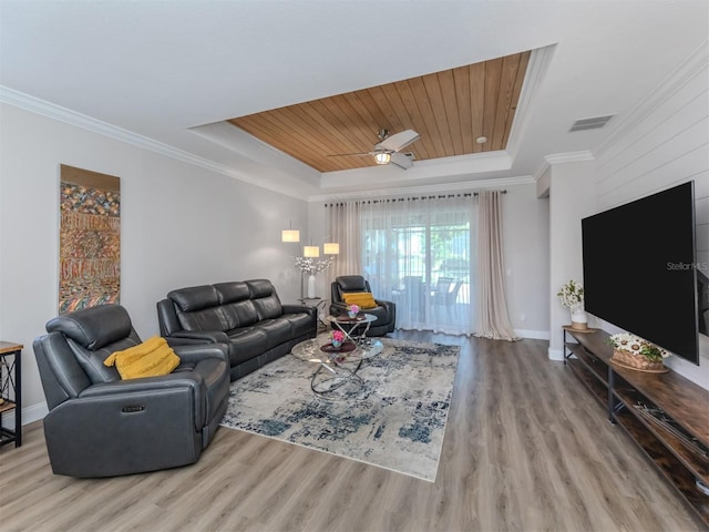living room featuring wood finished floors, visible vents, crown molding, a raised ceiling, and wooden ceiling