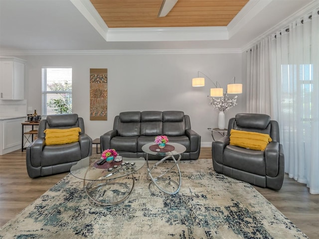 living room featuring ornamental molding, wood ceiling, a tray ceiling, and wood finished floors