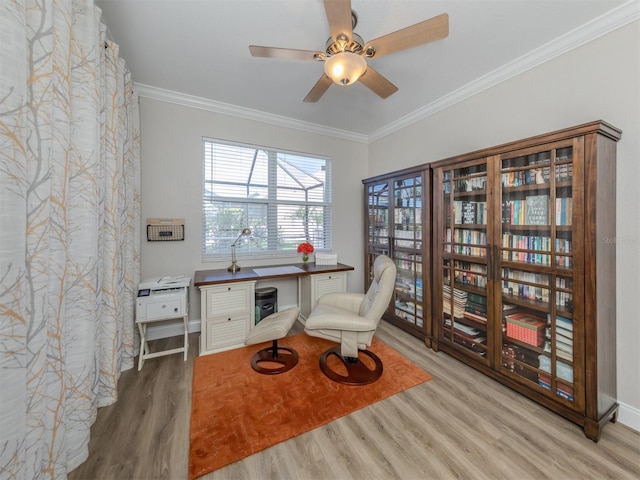 office area with wood finished floors, ornamental molding, and a ceiling fan