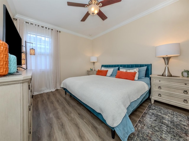 bedroom with ceiling fan, dark wood-style floors, and crown molding
