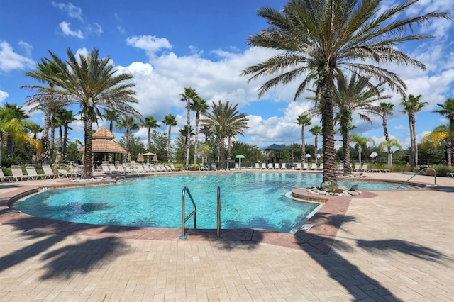 pool with a gazebo and a patio area