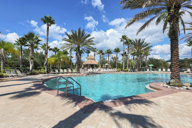pool with a gazebo and a patio