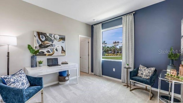 living area with baseboards and carpet