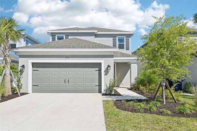 traditional-style home with stucco siding, an attached garage, concrete driveway, and roof with shingles