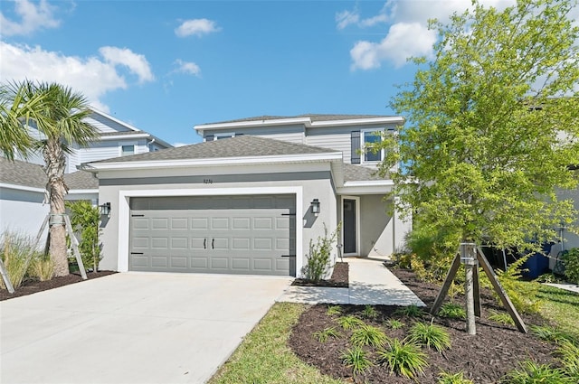 view of front of home with stucco siding, roof with shingles, concrete driveway, and an attached garage