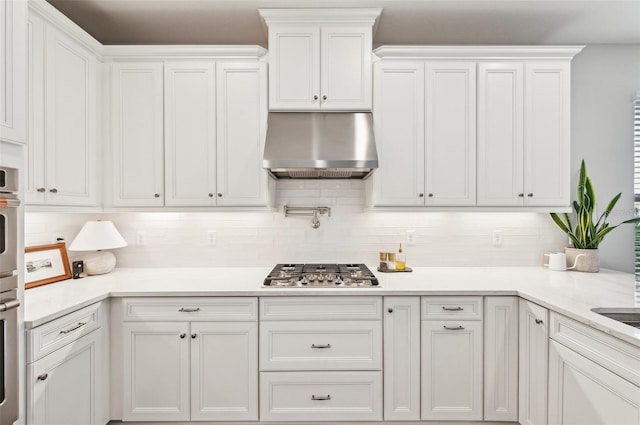 kitchen with white cabinetry, under cabinet range hood, and stainless steel gas cooktop