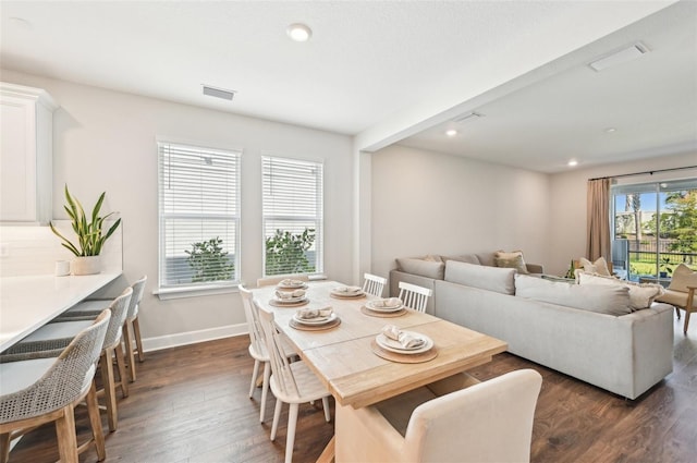 dining space with dark wood finished floors, visible vents, recessed lighting, and baseboards